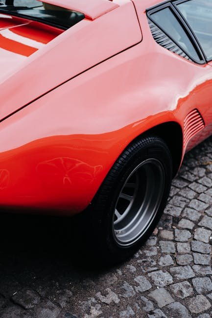 Luxury Cars - Close-up of a classic red sports car on a cobble #11213277