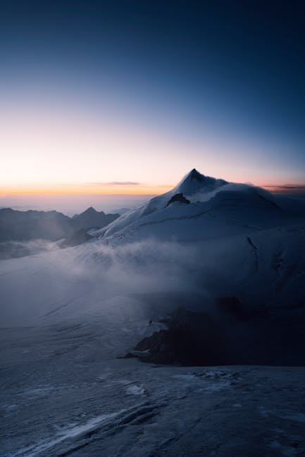 Mountain Landscapes - Breathtaking view of a snowcapped mountain peak #13449836