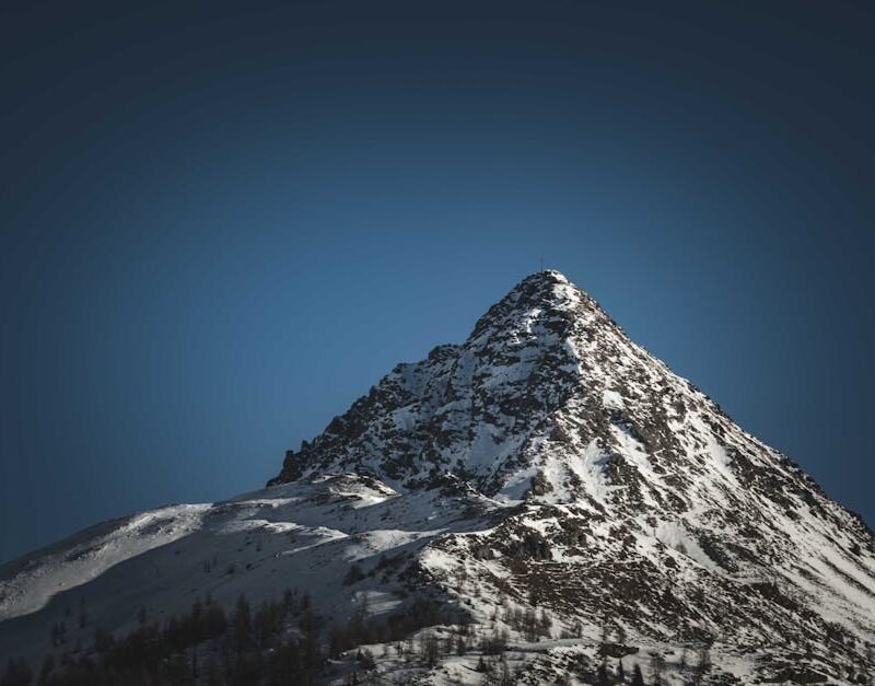 Mountain Landscapes - Majestic snow-covered mountain peak rising benea #20013643
