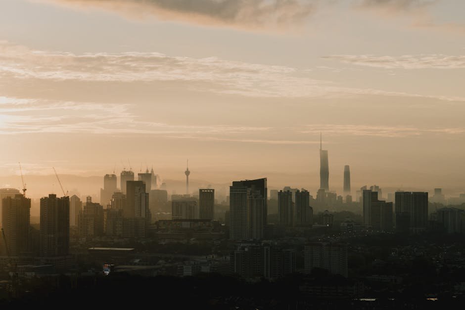 City Architecture - Silhouette of Kuala Lumpur skyline during sunris #33374886