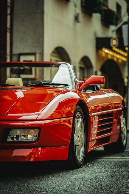Luxury Cars - Sleek red Ferrari parked on city street, epitomi #35189512